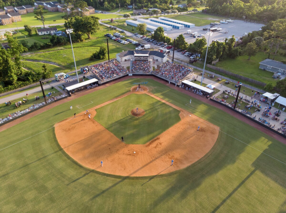 Aerial view of Big Rock Stadium in Morehead City during a Marlins game, grandstand full at golden hour